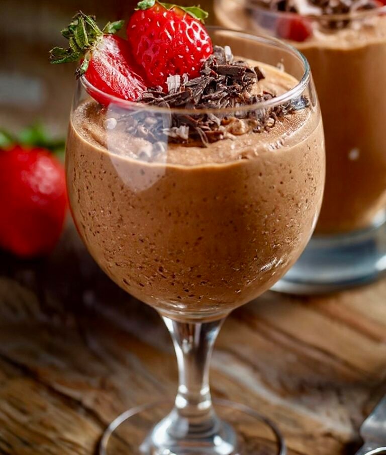 A crystal glass filled with airy, velvety 3-ingredient Nutella mousse topped with a fresh strawberry and chocolate shavings.