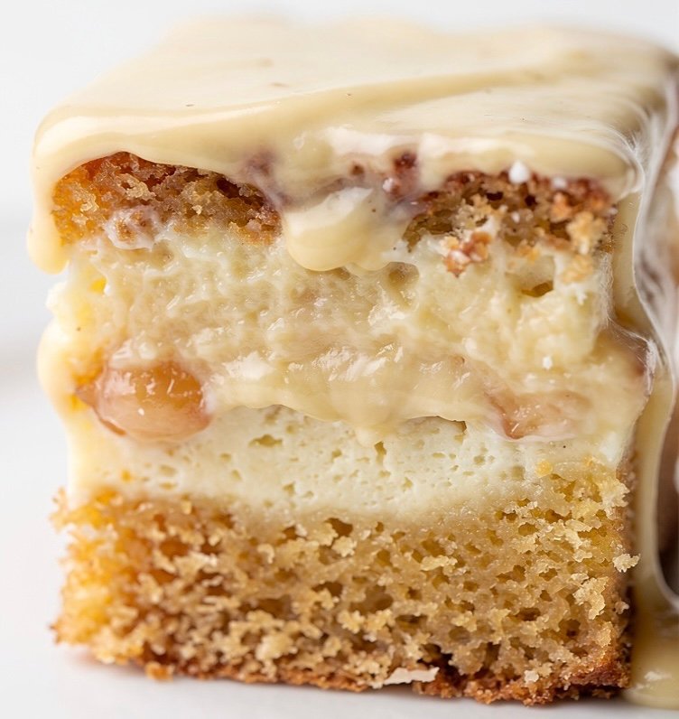 Neiman Marcus cake. A close-up shot of a sliced square of The Best Easy Neiman Marcus Cake (So Good) showing the gooey cream cheese layer.